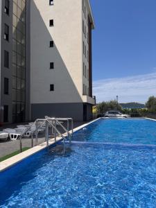 a swimming pool in front of a building at Apartment by Bar in Bar +8 photos