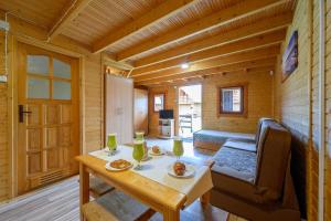 a dining room with a table in a log cabin at Domki letniskowe Nevada in Darlowko