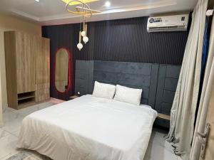 a bedroom with a white bed in a room at Modern 2 BR apartment in Lekki