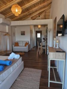 a living room with a couch and a table at Lovely Sea View Apartments & Junior Suites in Himare