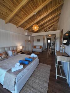 a bedroom with a large bed with blue pillows at Lovely Sea View Apartments & Junior Suites in Himare +57 photos