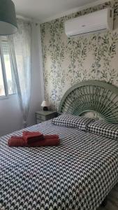 a bedroom with a large bed with a checkered blanket at Apartments in Alicante +12 photos