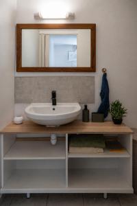 a bathroom with a sink and a mirror at Kay Canou - Vue jardin tropical - Calme & nature in Le Robert