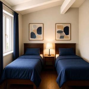a bedroom with two beds and a window at VAIL MOUNTAIN SUITE in Vail