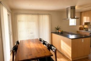 a kitchen with a wooden table and some chairs at VAIL MOUNTAIN SUITE in Vail