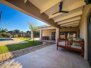 a porch of a house with a ceiling fan at Judith & Sylvester Hideaway in Victoria Falls