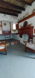 a living room with a couch and a table and chairs at Tinas House in Afiartis