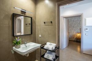 a bathroom with a sink and a mirror at Ivy Residences with Pool in Ayía Varvára +37 photos