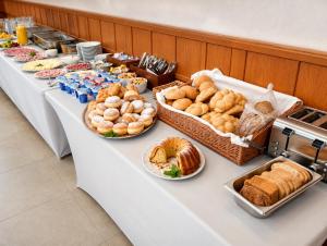 a buffet line with various types of bread and pastries at Hotel Casanova in Duchcov +16 photos