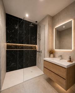a bathroom with a shower and a sink and a mirror at Château Alto Cormeil in Saint-Émilion