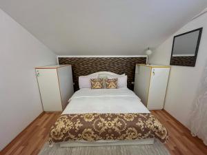 a bedroom with a large bed and two cabinets at Villa Diamond Hill in Sarajevo +64 photos