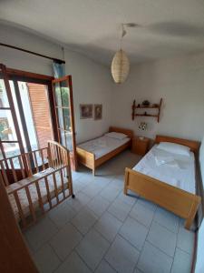 a bedroom with two beds and a couch in it at Pax Summer Apartment in Siviri
