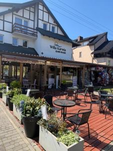 a patio with tables and chairs in front of a building at Willa Karwia in Karwia