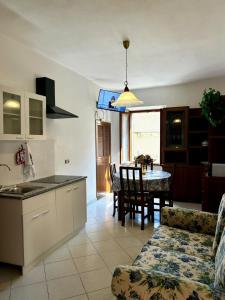 a kitchen and a living room with a table and a kitchen at Bastianina's home in Marciana Marina