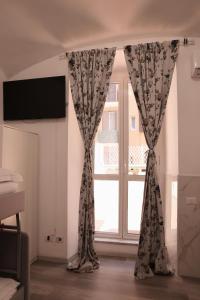 a window with curtains in a room at Western Termini Guest House in Rome