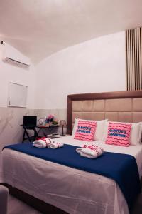 a bedroom with a large bed with pink and blue sheets at Western Termini Guest House in Rome