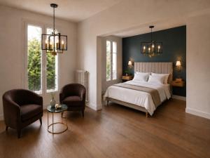 a bedroom with a large bed and two chairs at Château Alto Cormeil in Saint-Émilion +12 photos