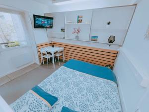 a bedroom with a bed and a table and a television at Cosy logement Hyper Centre-ville in Quimper