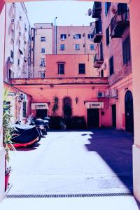a parking lot in front of a pink building at Western Termini Guest House in Rome