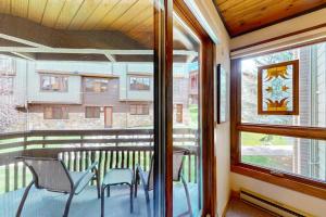 a balcony with chairs and a table and a window at The Lodge at Steamboat in Steamboat Springs +56 photos