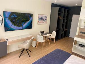 a room with a desk and chairs and a table at Ahiva Village in Fulhadhoo +37 photos