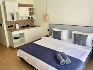 a bedroom with a bed with two pillows on it at Ahiva Village in Fulhadhoo