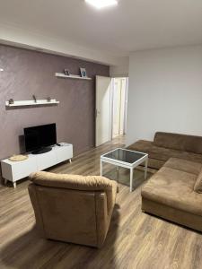 a living room with a couch and a coffee table at Apartman Ðurđevak in Stara Pazova