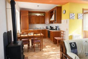 a kitchen and dining room with a wood stove at Casa Maria in Pettenasco