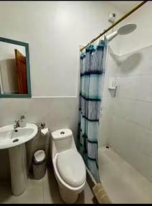 a bathroom with a toilet and a sink and a shower at Hostal Cabañas Don Jorge in Puerto Baquerizo Moreno +58 photos