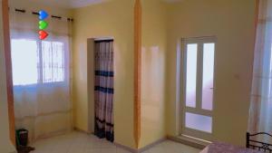 an empty room with a window and a door at Keur Massar Tolou Laye WADE in Niadyorane +18 photos