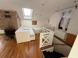 a room with two beds and a television in it at Noclegi AirportPark in Pyrzowice