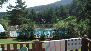 a view of a swimming pool from a wooden fence at Camping montagne in Camurac +9 photos