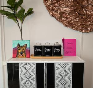 a shelf with three pictures of a dog on it at Majatalo Mäntän Kuusela in Mänttä