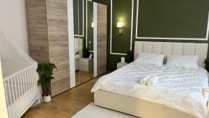 a bedroom with a white bed and a mirror at Studio Yas Central Arad in Arad