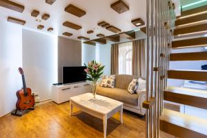 a living room with a couch and a guitar at Ali Baba Apartment in Mostar