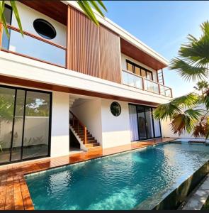 a house with a swimming pool in front of it at Hey-Sola Bali ,3BR Luxury Private Villa Near Canggu in Dalung
