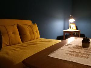a bedroom with a bed and a table with a lamp at Ferienwohnung Prignitzhof in Plattenburg