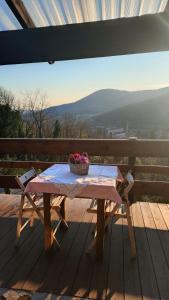 a picnic table with a basket of fruit on a deck at B&B Sella Klancic in San Pietro al Natisone +2 photos
