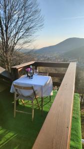 a table with a white table cloth on top of grass at B&B Sella Klancic in San Pietro al Natisone