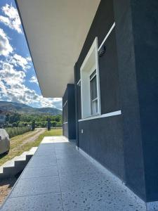 a building with a window on the side of it at Prive Home in Maliq