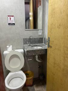 a bathroom with a toilet and a sink at Hostel Sossego do Garças in Barra do Garças +18 photos