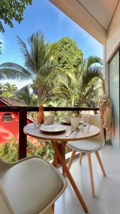 a table and two chairs on a balcony at Mirante das Conchas - Melhor Localização in Itacaré