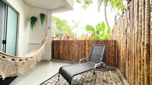 a patio with a hammock and a fence at Mirante das Conchas - Melhor Localização in Itacaré
