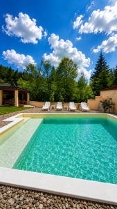 a swimming pool with blue water in a yard at Planinska Oaza in Pale