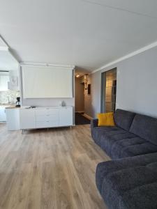 a living room with a couch and a flat screen tv at Comfort apartment in Rakvere in Rakvere