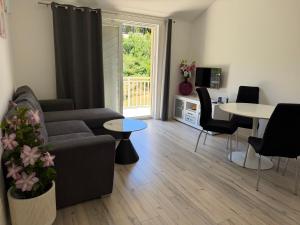 a living room with a couch and a table at Relax Zone Apartment in Trsteno