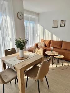 a living room with a wooden table and chairs at Nest apartman 2 in Veliko Gradište