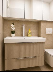 a bathroom with a sink and a toilet at Euforia Ma Apartment Sarajevo in Sarajevo +19 photos