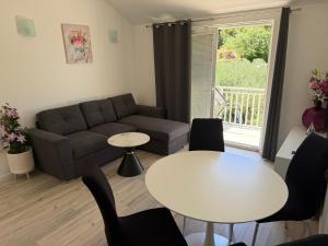a living room with a couch and a table at Relax Zone Apartment in Trsteno
