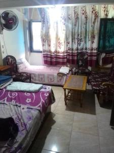 a room with beds and a table and a window at ادفو 35سرير ثلاثي in Alexandria